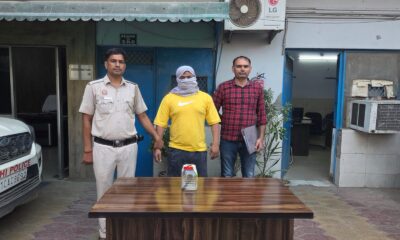 Police with two detained individuals.