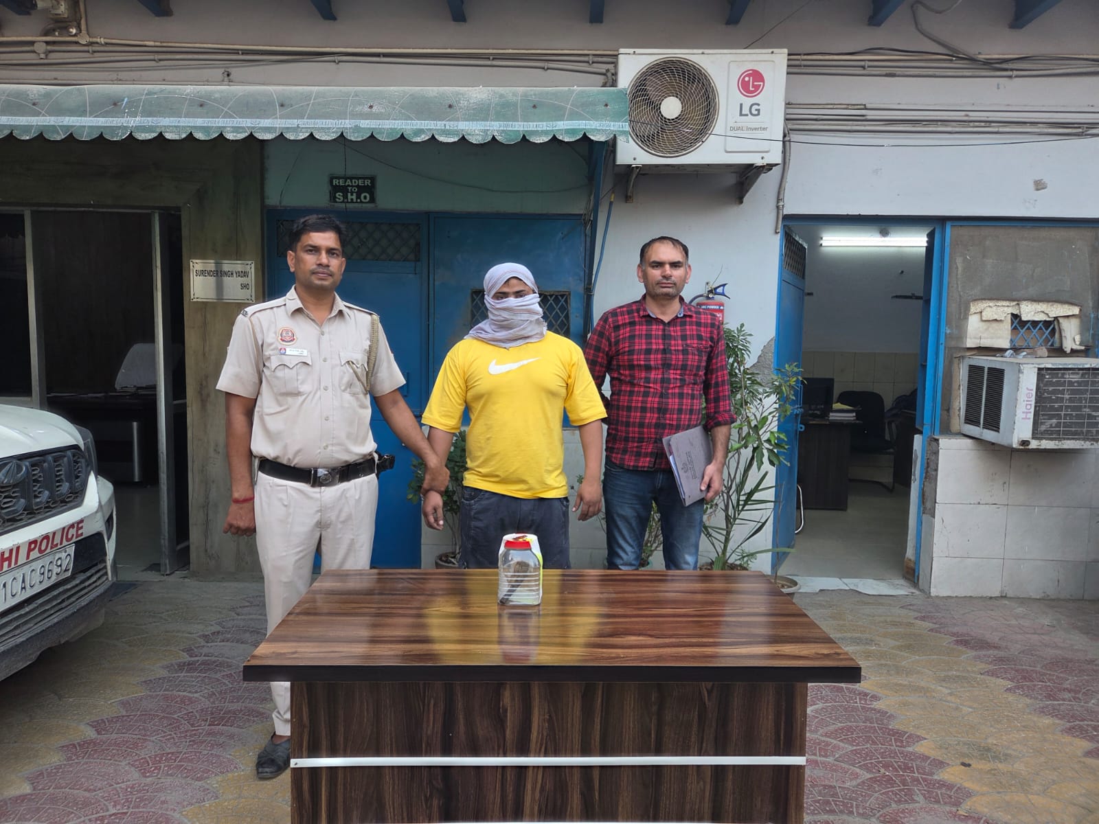 Police with two detained individuals.