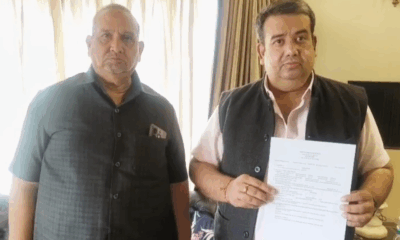 Two men holding a document.